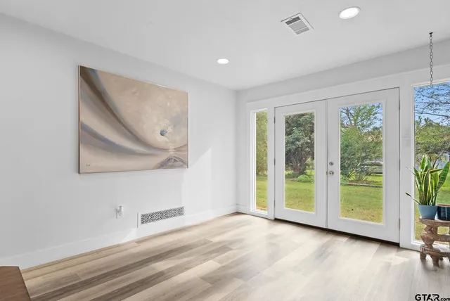 a view of a room with wooden floor and window