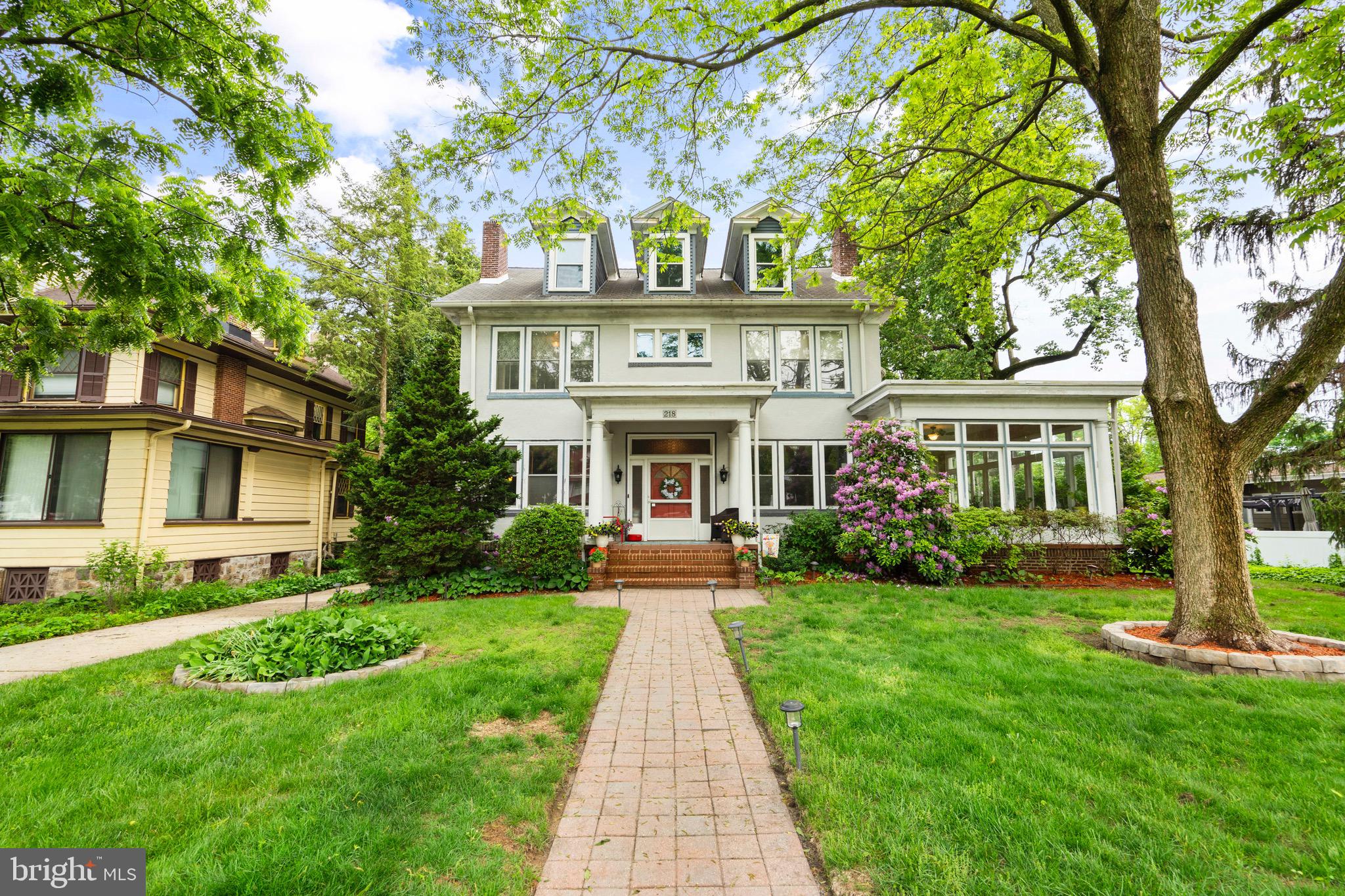 218 East Maple Avenue Merchantville, NJ 08109 - Photo 1 of 56 a front view of a house with garden and trees