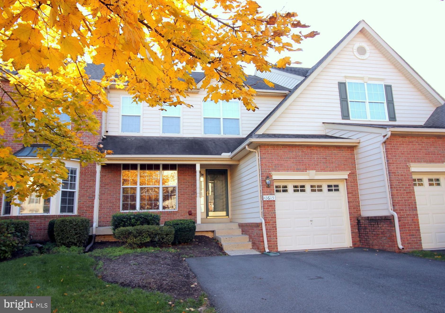 43605 Ryder Cup Square Ashburn, VA 20147 - Photo 29 of 48 a front view of a house with a yard and garage