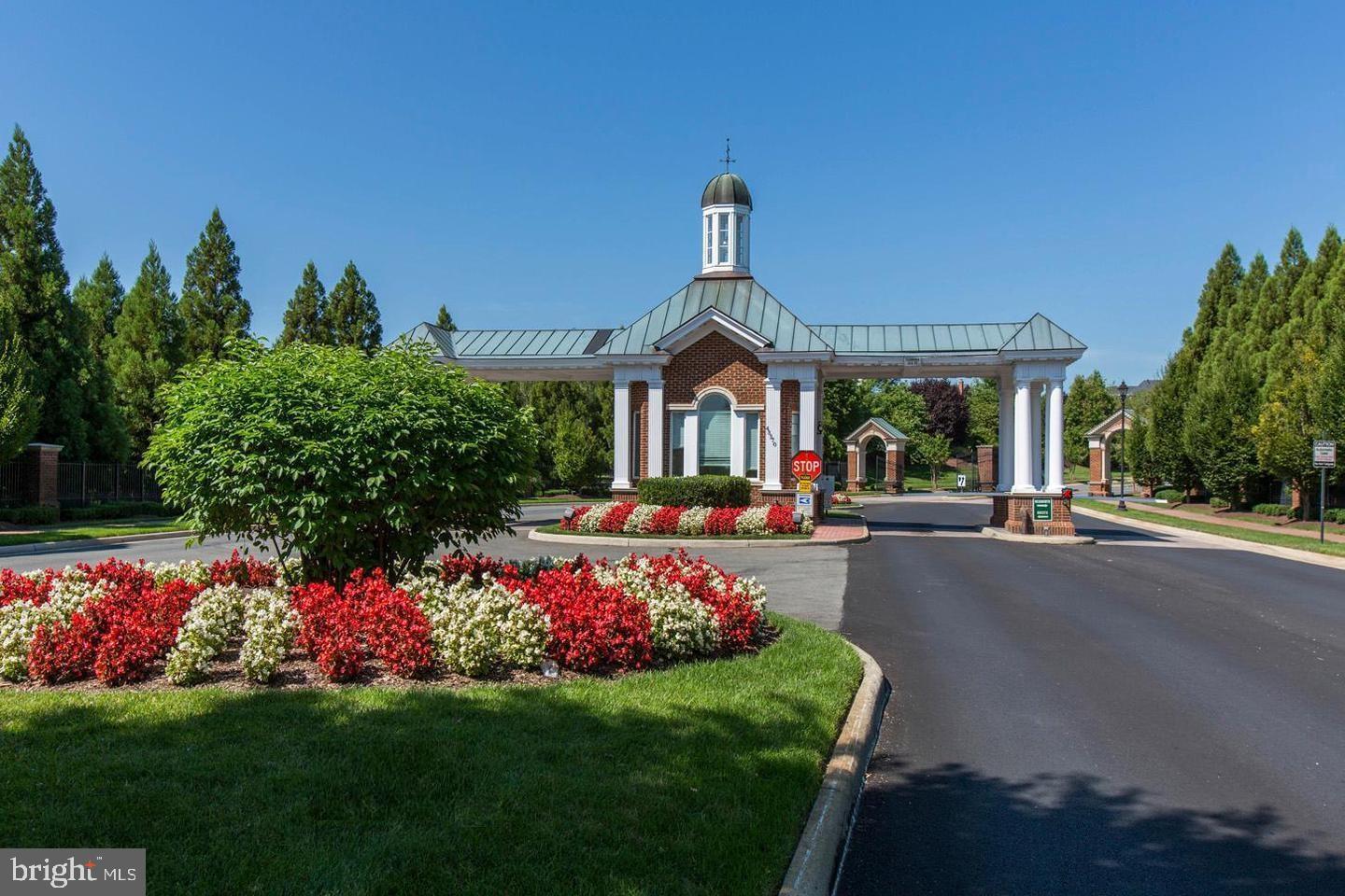 43605 Ryder Cup Square Ashburn, VA 20147 - Photo 32 of 48 a front view of a house with a big yard and potted plants