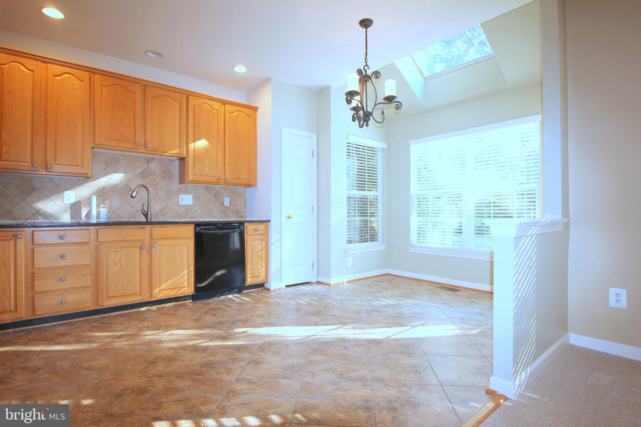 43605 Ryder Cup Square Ashburn, VA 20147 - Photo 5 of 48 a view of a kitchen with a sink and a window