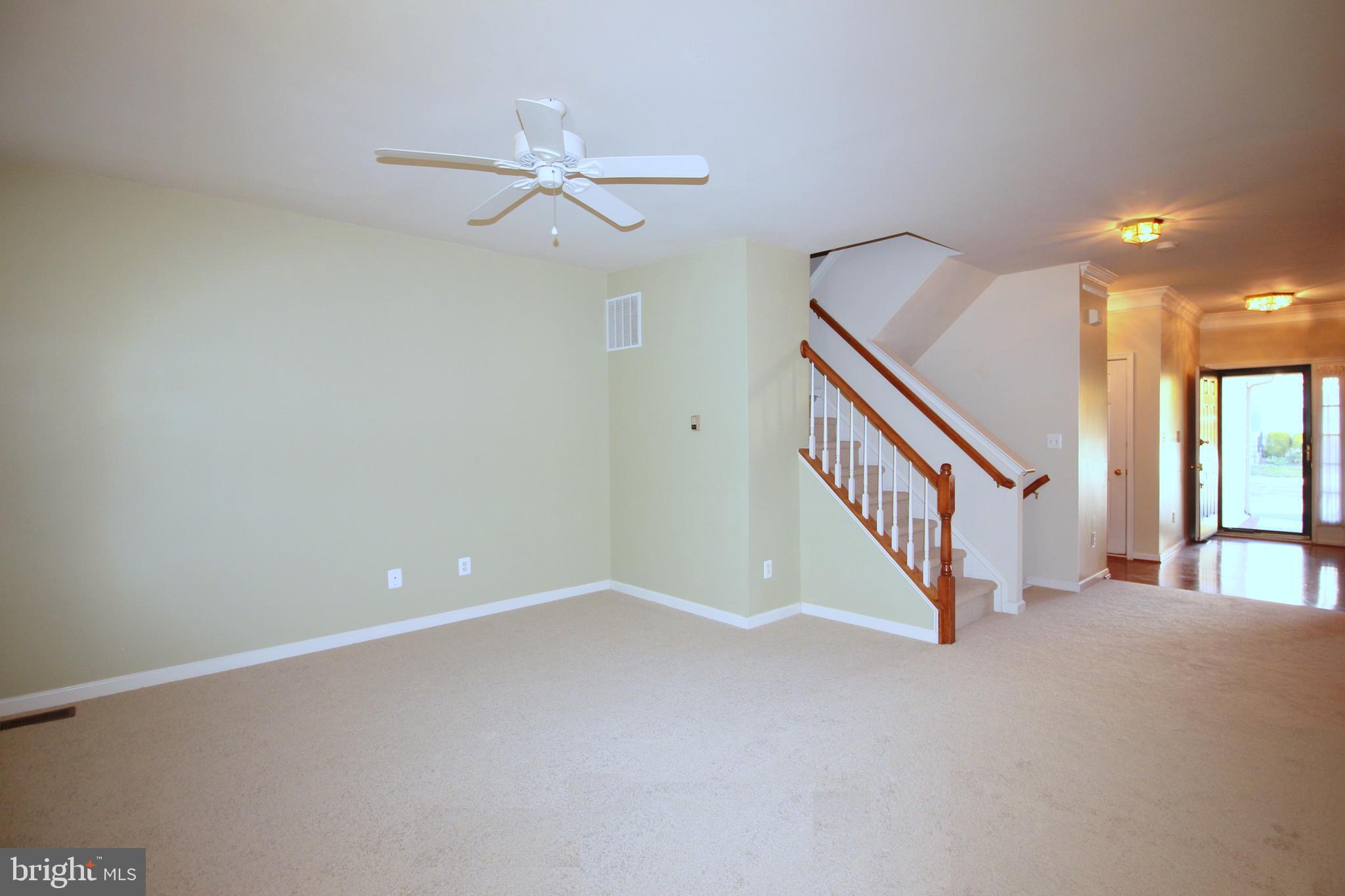 43605 Ryder Cup Square Ashburn, VA 20147 - Photo 47 of 48 a view of an empty room with staircase and a chandelier fan