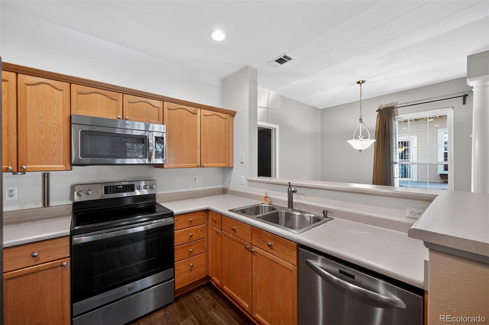 4064 South Carson Street, Unit 101 Aurora, CO 80014 - Photo 21 of 32 a kitchen with a sink stove and microwave