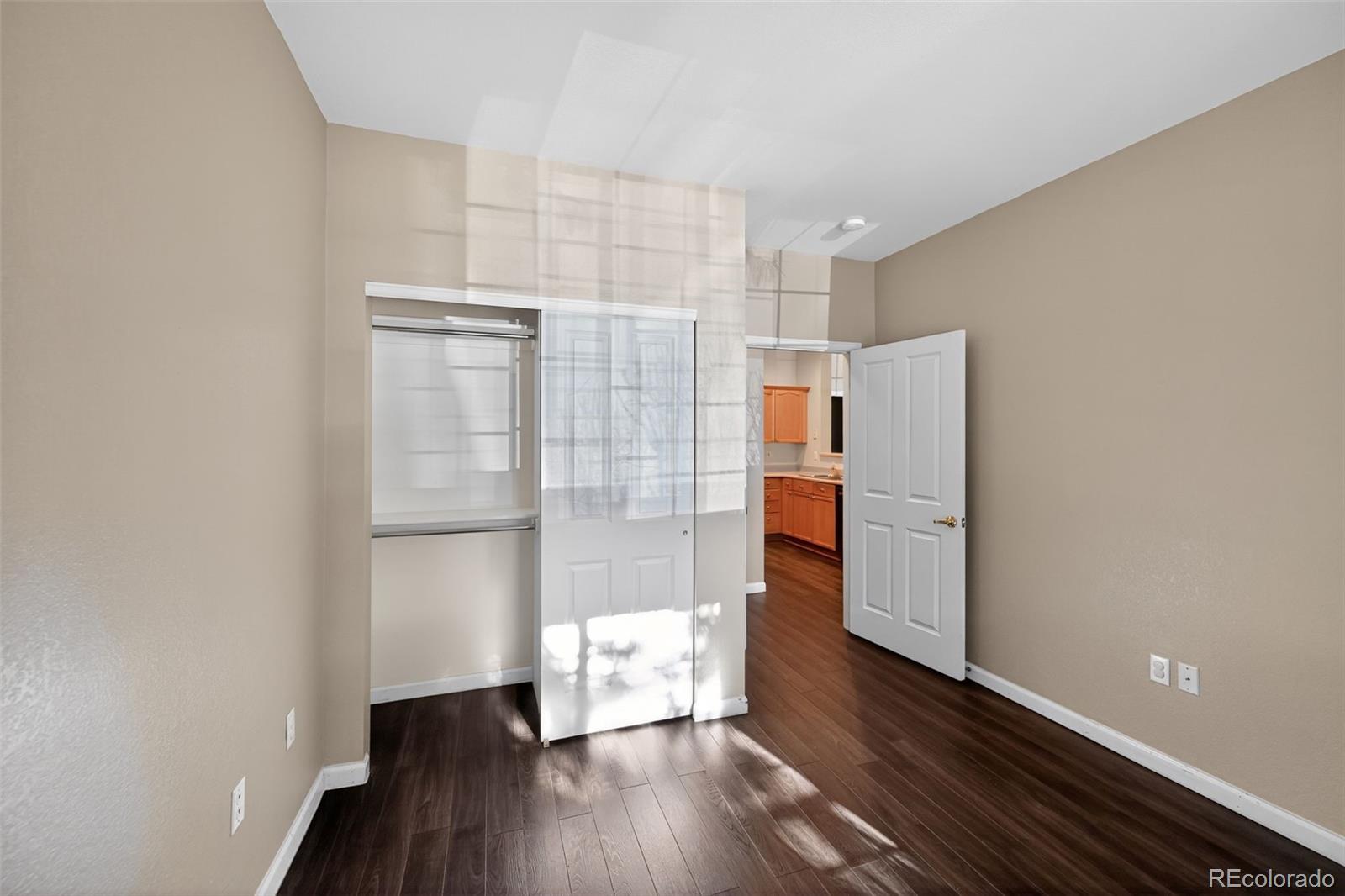 4064 South Carson Street, Unit 101 Aurora, CO 80014 - Photo 26 of 32 a view of empty room with wooden floor and cabinet