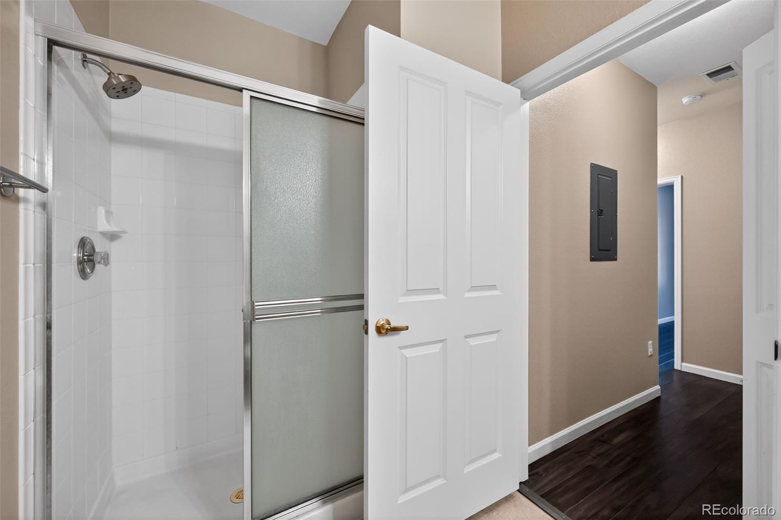 4064 South Carson Street, Unit 101 Aurora, CO 80014 - Photo 31 of 32 a bathroom with a glass shower door
