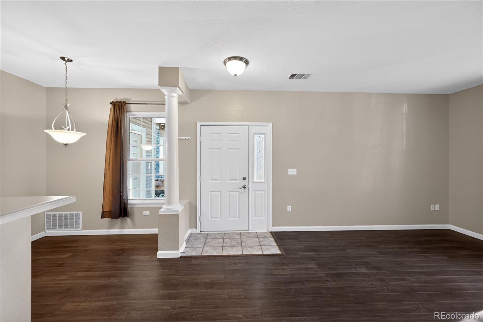 4064 South Carson Street, Unit 101 Aurora, CO 80014 - Photo 6 of 32 a view of empty room with wooden floor and fan