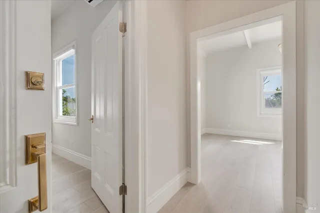 an empty room with closet and windows