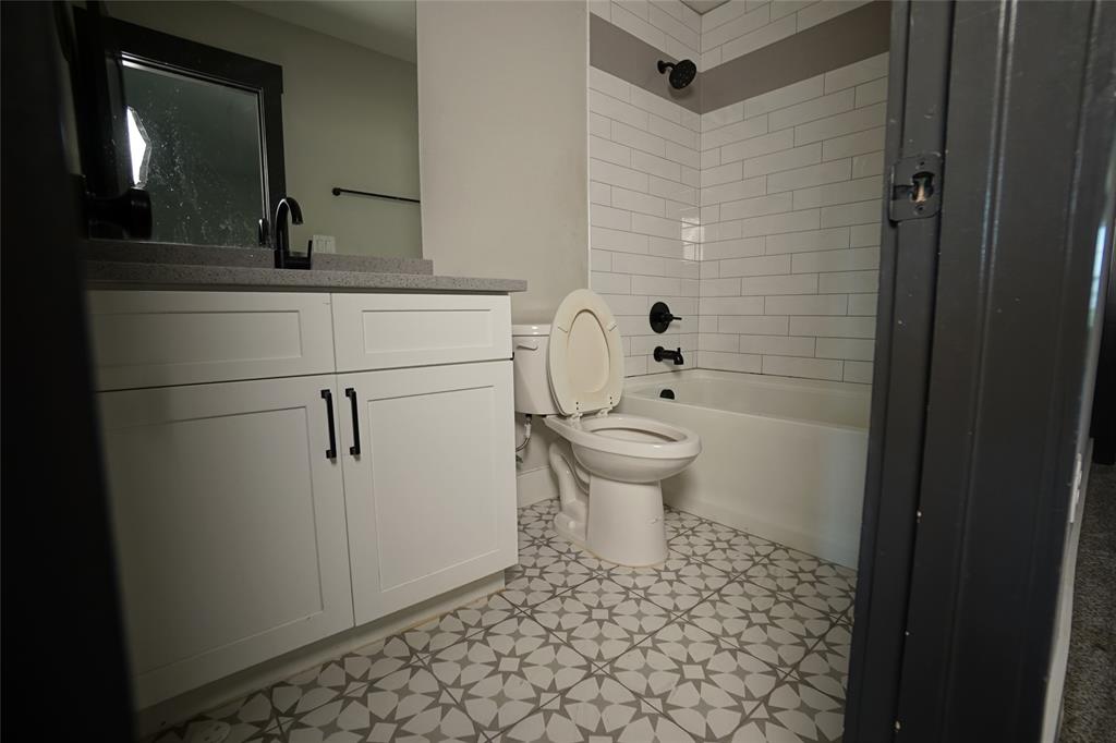 1764 Palladio Loop Princeton, TX 75407 - Photo 26 of 40 Bathroom featuring a white vanity with black hardware, a grey countertop, and a contemporary mirror