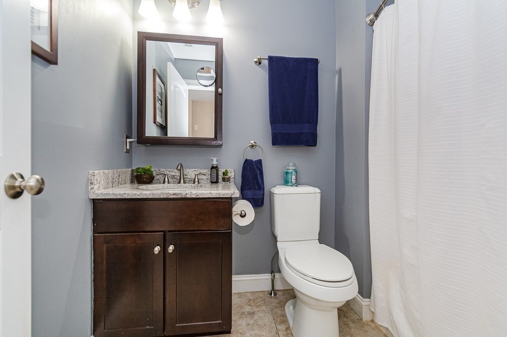 30 April's Way Tewksbury, MA 01876 - Photo 16 of 42 a bathroom with a toilet sink vanity and mirror