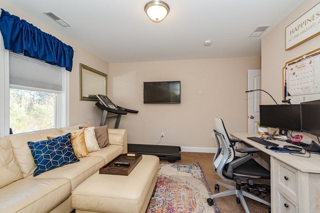 30 April's Way Tewksbury, MA 01876 - Photo 18 of 42 a living room with furniture and a flat screen tv