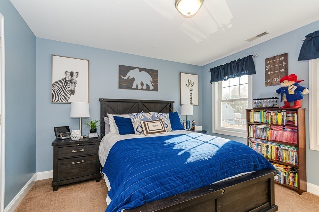 30 April's Way Tewksbury, MA 01876 - Photo 19 of 42 a bed sitting in a bedroom next to a window