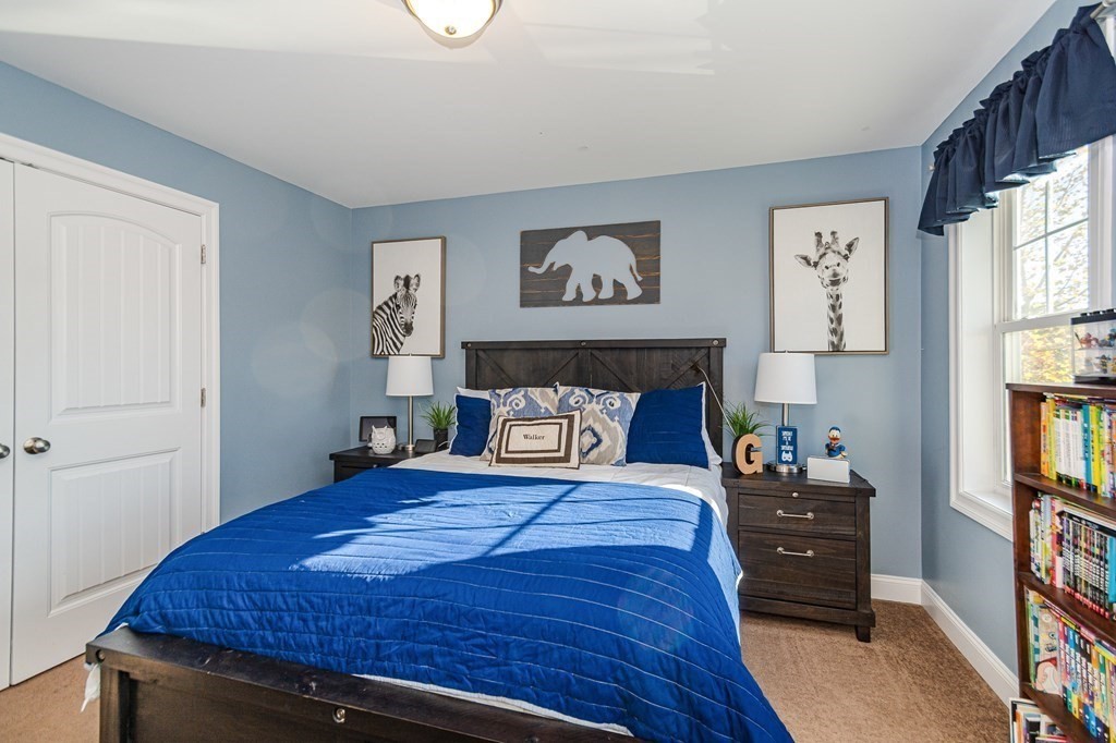 30 April's Way Tewksbury, MA 01876 - Photo 20 of 42 a bedroom with a bed and a bookshelf