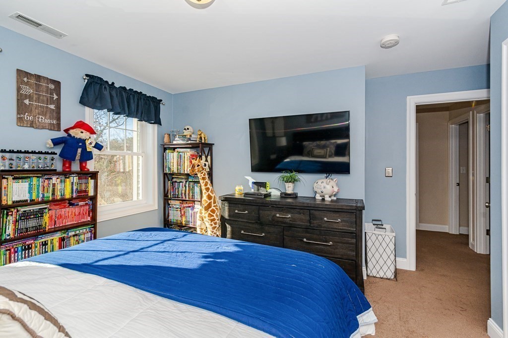 30 April's Way Tewksbury, MA 01876 - Photo 21 of 42 a bedroom with a bed and a flat screen tv