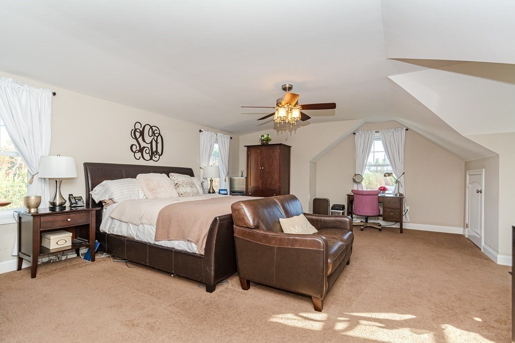 30 April's Way Tewksbury, MA 01876 - Photo 23 of 42 a spacious bedroom with a bed and a chandelier