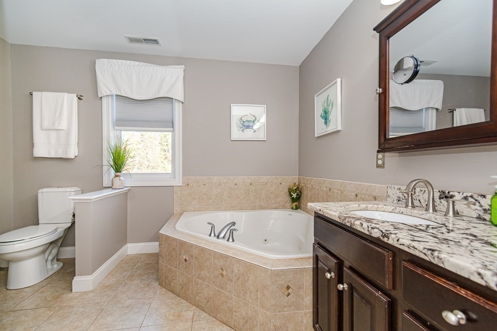 30 April's Way Tewksbury, MA 01876 - Photo 26 of 42 a bathroom with a granite countertop bathtub sink vanity mirror and toilet