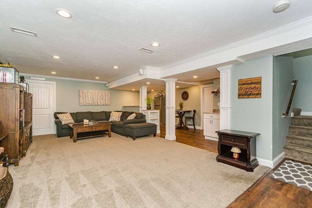30 April's Way Tewksbury, MA 01876 - Photo 29 of 42 a living room with furniture a fireplace and a flat screen tv