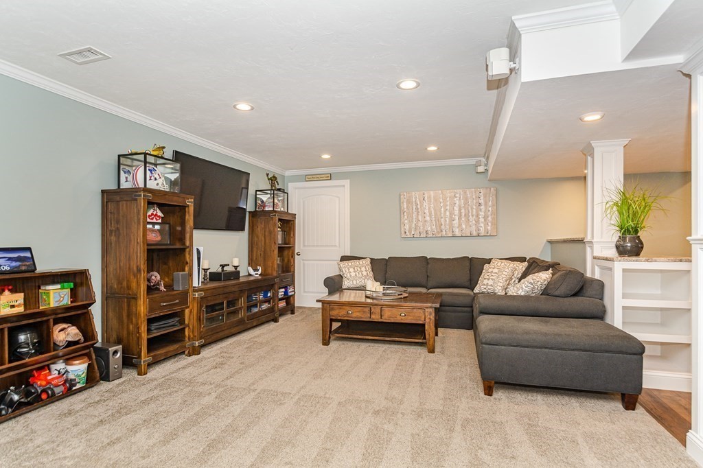 30 April's Way Tewksbury, MA 01876 - Photo 30 of 42 a living room with furniture and a flat screen tv