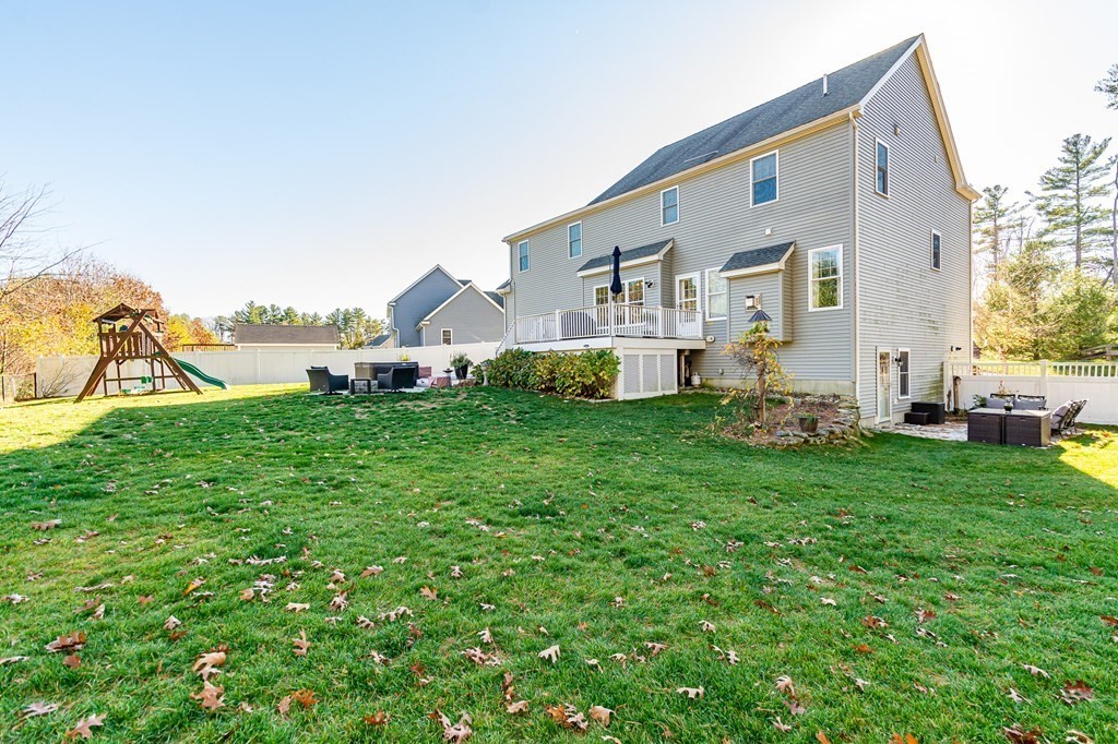 30 April's Way Tewksbury, MA 01876 - Photo 36 of 42 a front view of a house with a yard and garage