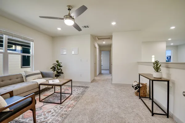 an empty room with windows and painting on the wall