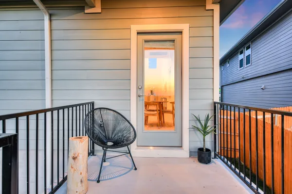 a view of a house with a yard and a large tree