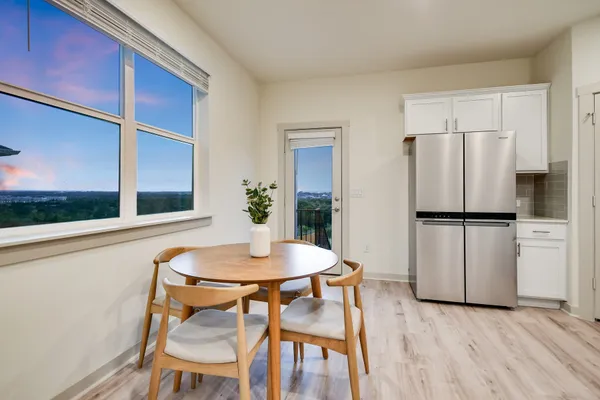 a kitchen with kitchen island wooden floors appliances and cabinets
