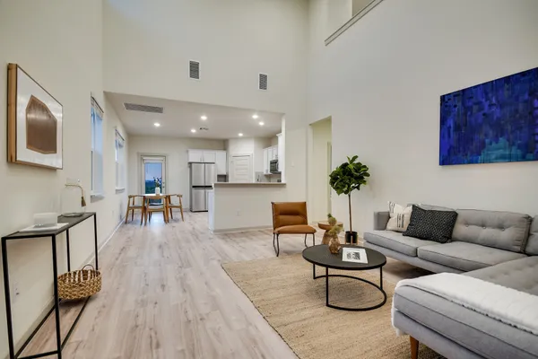 a living room with furniture and wooden floor