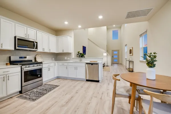 a kitchen with a stove a sink and a microwave