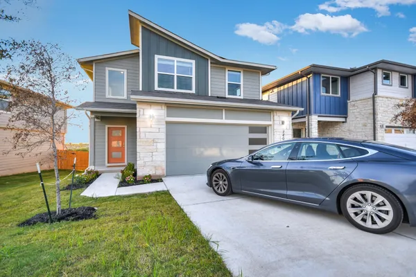 a kitchen with a refrigerator stove and white cabinets