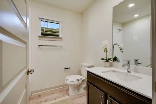 a bedroom with a bed potted plant and a window