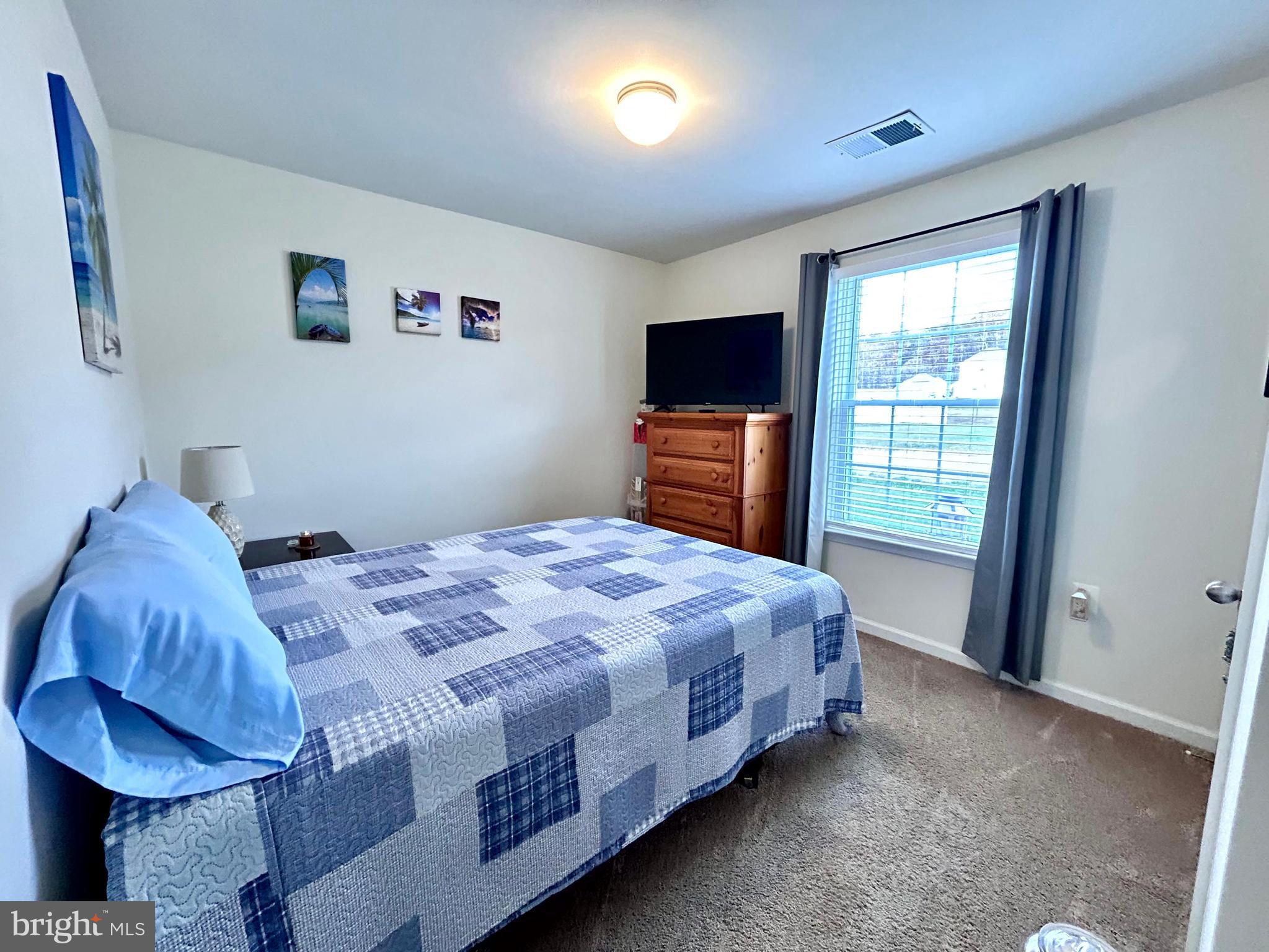 90 Rappahannock Run Falling Waters, WV 25419 - Photo 19 of 47 a bedroom with a bed and a flat screen tv