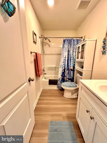 a view of a hallway with wooden floor and stairs