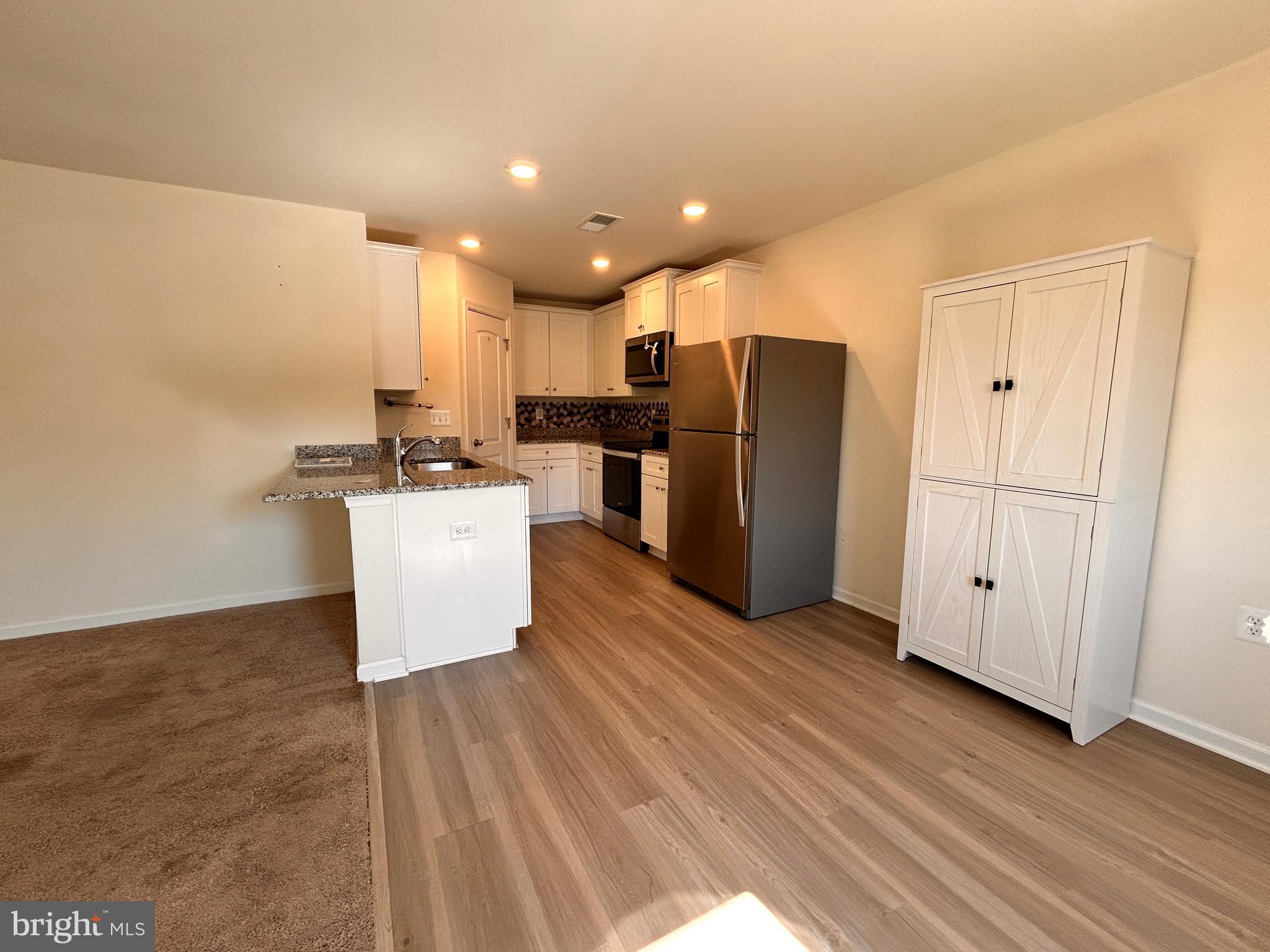 90 Rappahannock Run Falling Waters, WV 25419 - Photo 4 of 48 a view of kitchen with stainless steel appliances wooden floor and cabinets