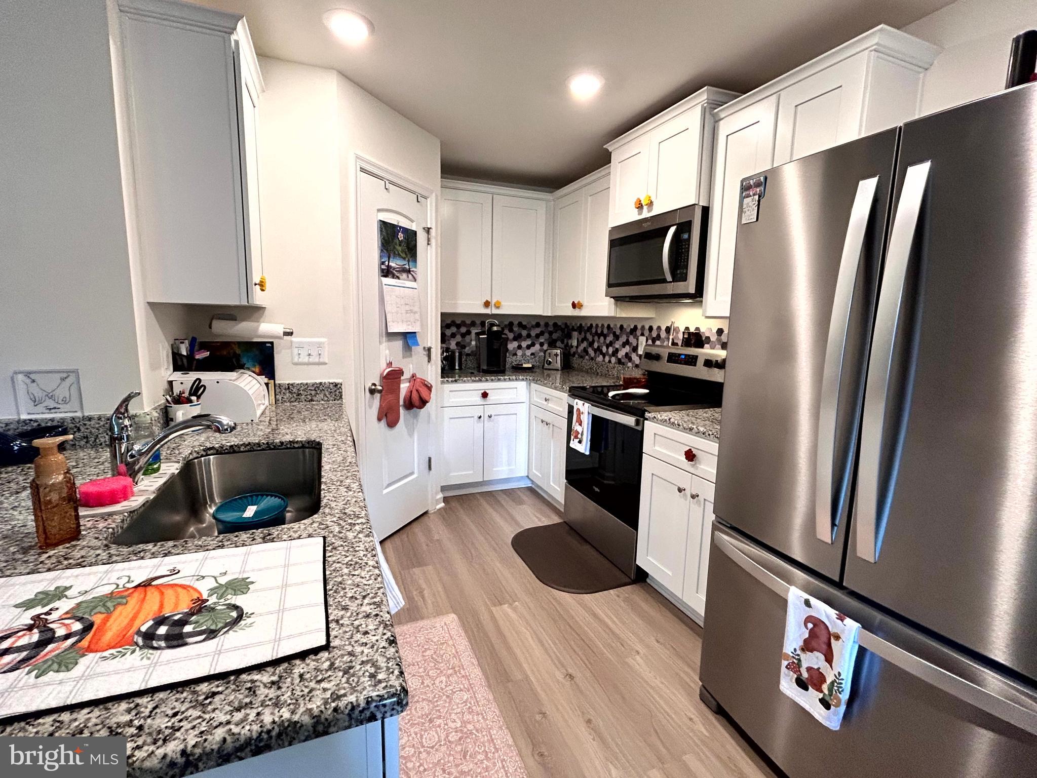 90 Rappahannock Run Falling Waters, WV 25419 - Photo 6 of 47 a kitchen with stainless steel appliances granite countertop a refrigerator stove and sink