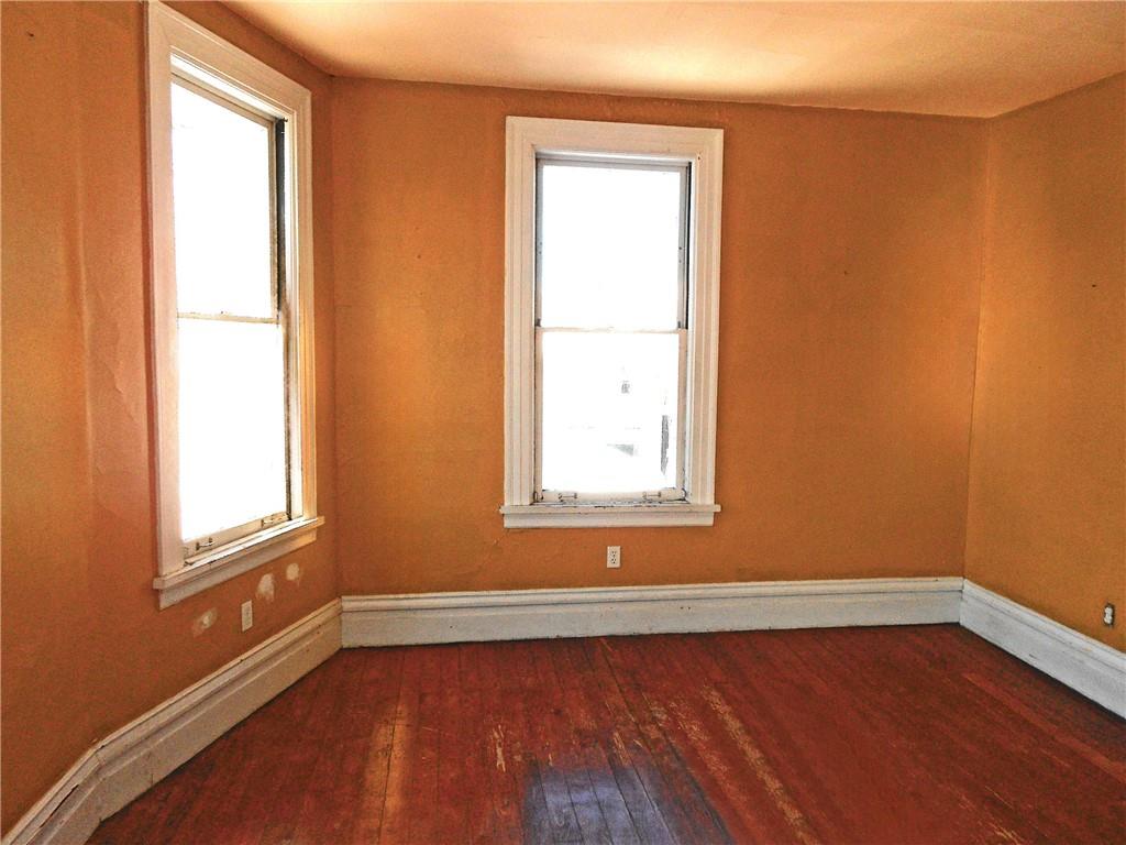601 Locust Place Sewickley, PA 15143 - Photo 11 of 23 an empty room with wooden floor and windows
