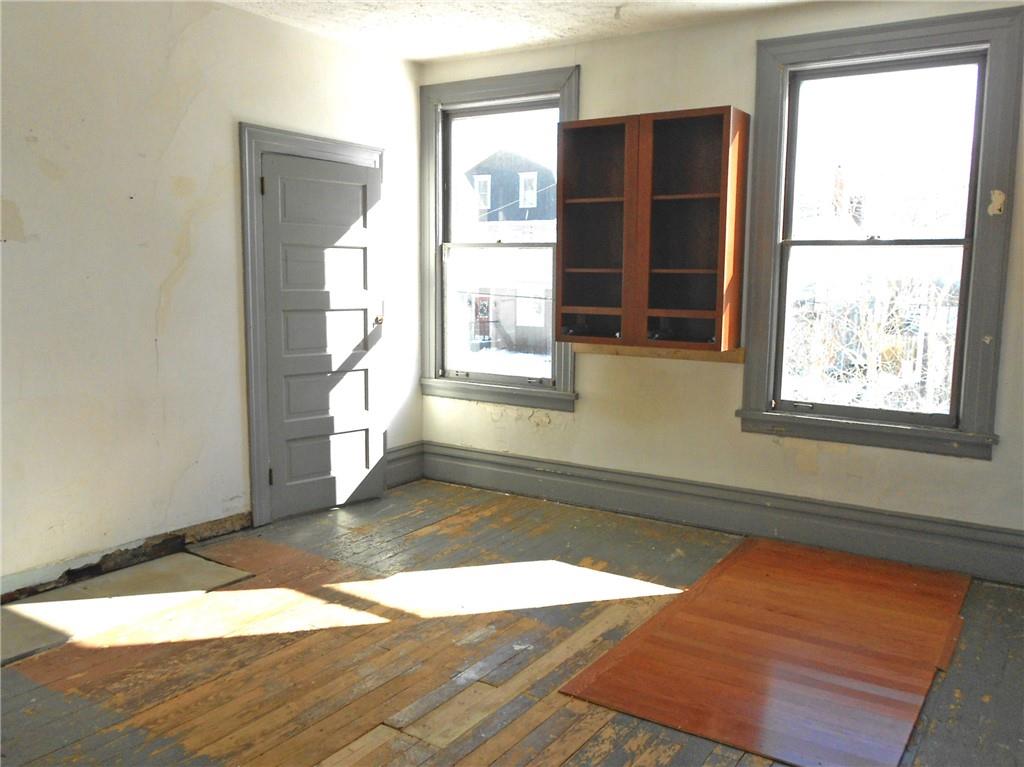 601 Locust Place Sewickley, PA 15143 - Photo 14 of 23 an empty room with wooden floor and windows