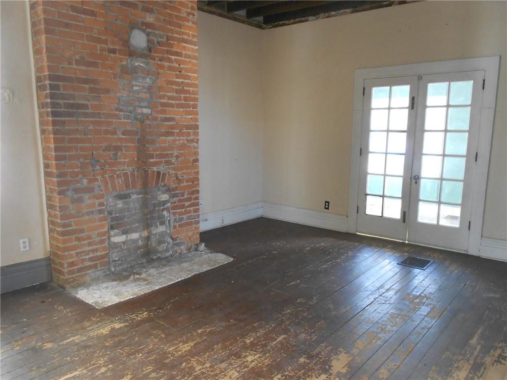 601 Locust Place Sewickley, PA 15143 - Photo 4 of 23 an empty room with wooden floor and windows
