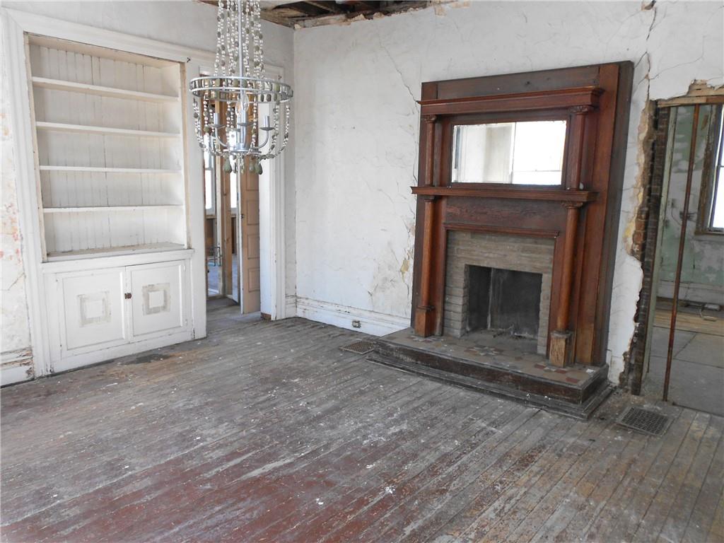 601 Locust Place Sewickley, PA 15143 - Photo 6 of 23 a view of empty room with a fireplace and chandelier