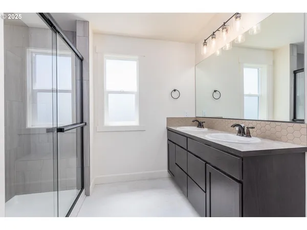 a bathroom with a sink a mirror and a shower
