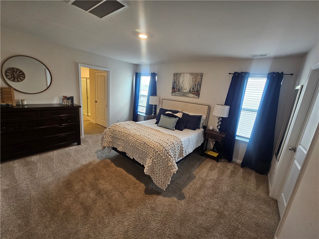 902 Ashwood Lane Easley, SC 29640 - Photo 21 of 39 A comfortable bedroom features plush carpeting and an en-suite bathroom entrance.
