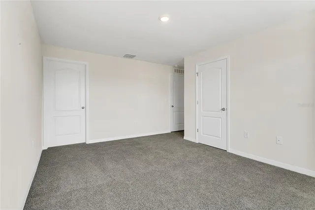 a view of walk in closet with empty racks