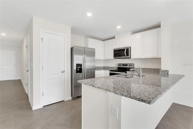 a kitchen with a sink stove and refrigerator