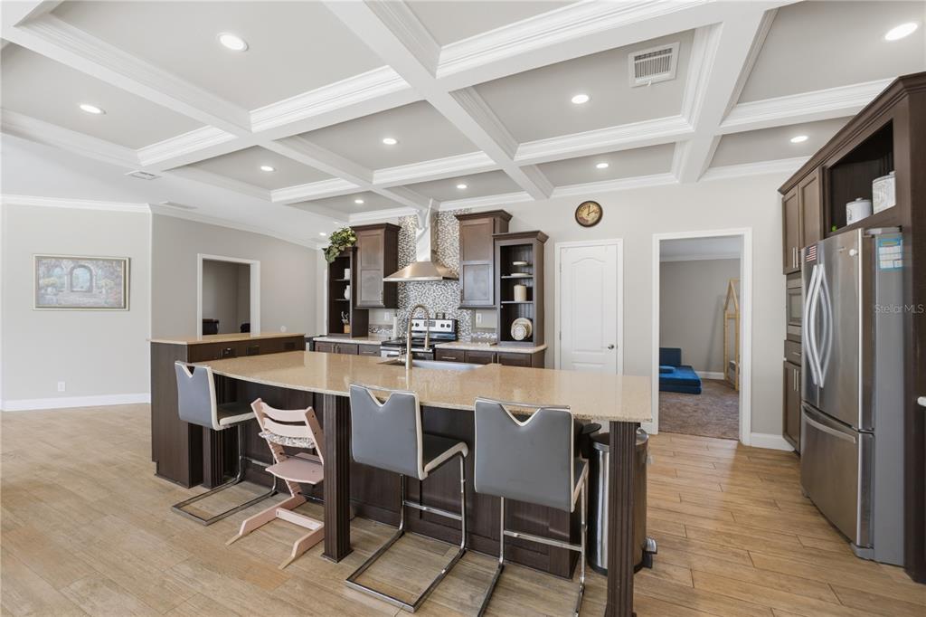 6844 Chad Jason Road St. Cloud, FL 34773 - Photo 16 of 59 a large kitchen with a table and chairs