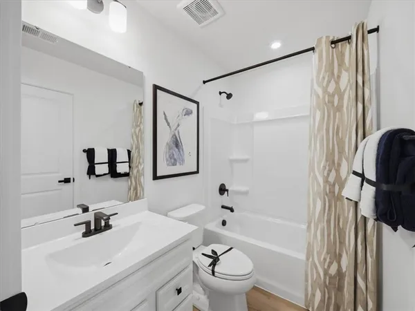 a bathroom with a sink toilet tub and shower