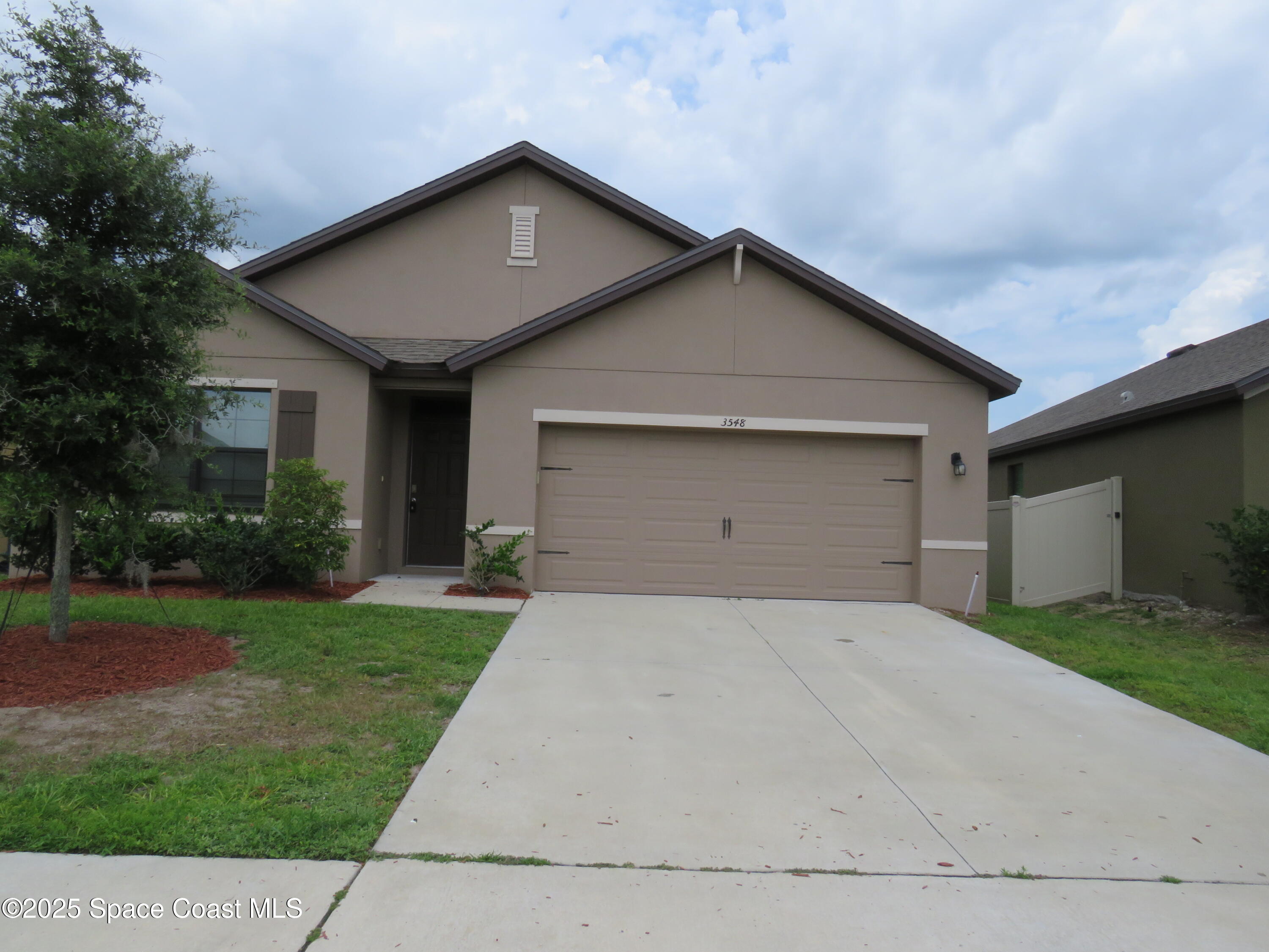 3548 Loggerhead Lane Mims, FL 32754 - Photo 1 of 25 a front view of house with yard and trees