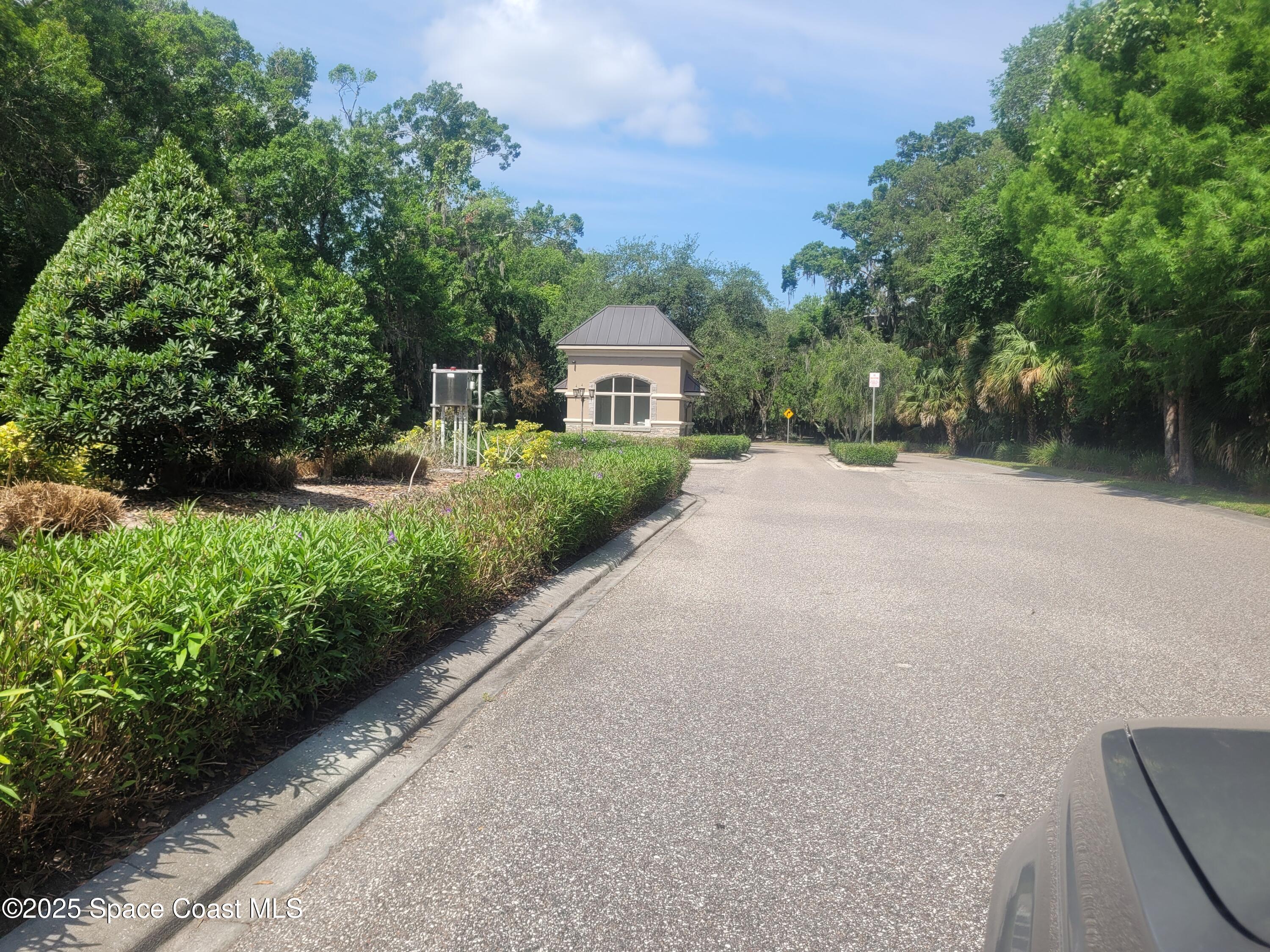 3548 Loggerhead Lane Mims, FL 32754 - Photo 2 of 25 a front view of a house with a garden and trees