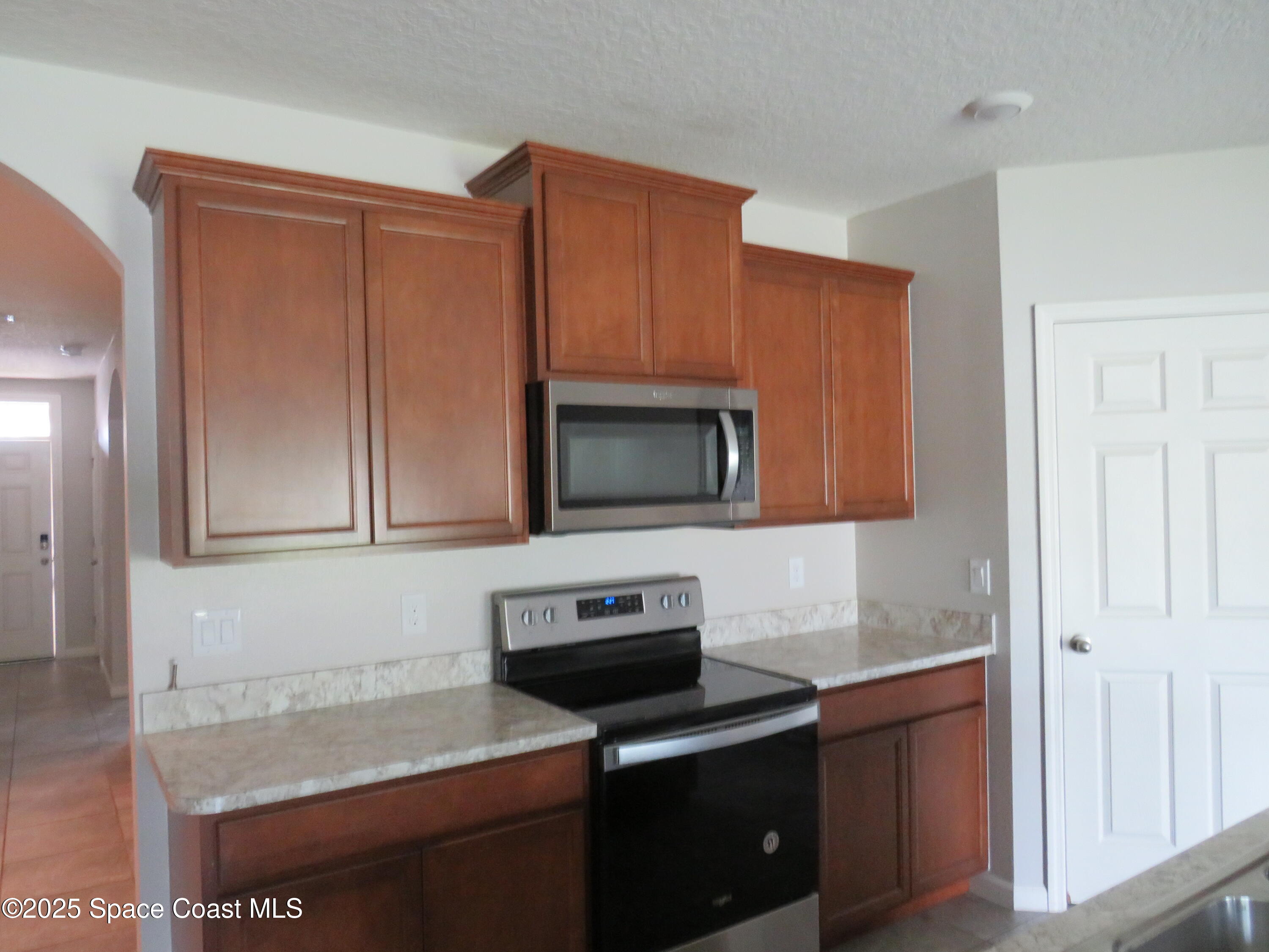3548 Loggerhead Lane Mims, FL 32754 - Photo 7 of 25 a kitchen with stainless steel appliances granite countertop a stove microwave and sink
