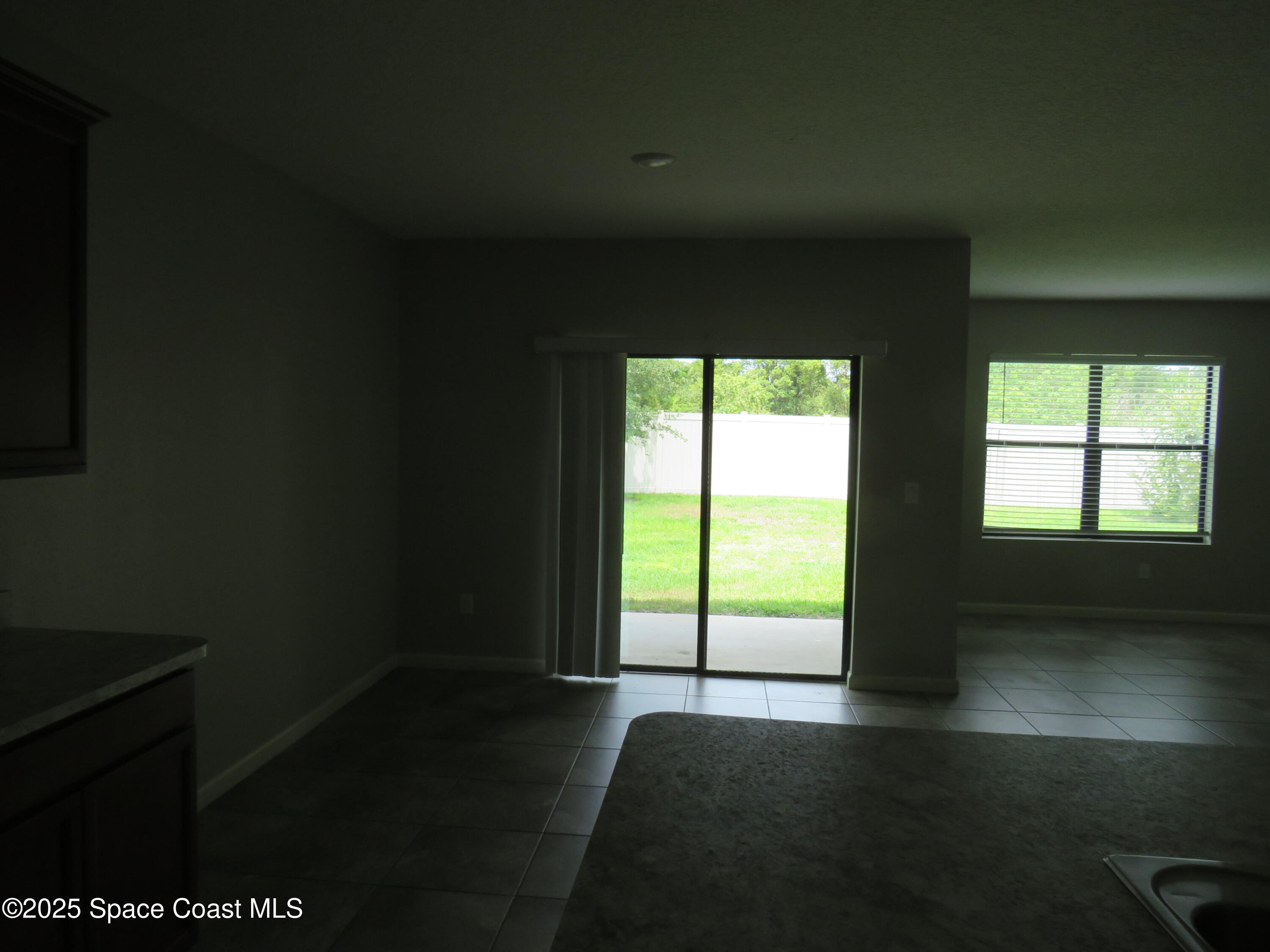 3548 Loggerhead Lane Mims, FL 32754 - Photo 10 of 25 a view of an empty room with wooden floor and a window