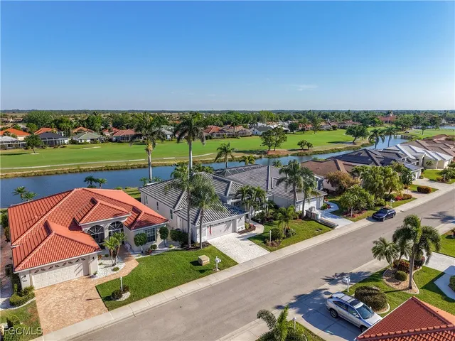 an aerial view of a house with a garden and lake view