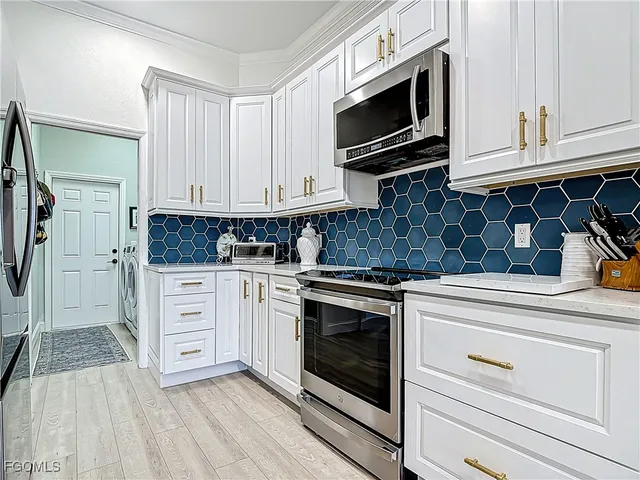 a kitchen with stainless steel appliances granite countertop a stove microwave and cabinets