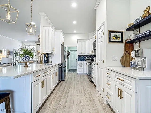 a large kitchen with stainless steel appliances lots of counter space and wooden floor